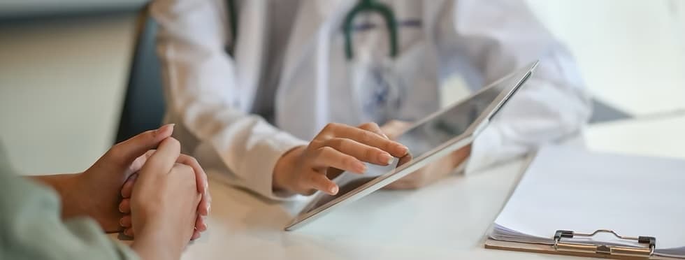 A healthcare professional discussing information with a patient